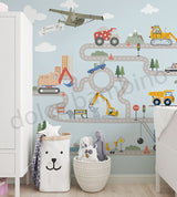 Children's room with a wall mural featuring construction vehicles and roads.