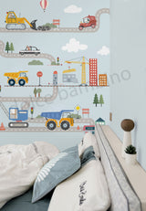 Children's room with construction-themed wall mural and bed.