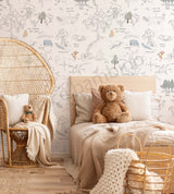 A wallpaper featuring characters from Winnie the Pooh in a forest setting, with a teddy bear, a basket, and a cushion, in a room with a bed and a wicker chair.
