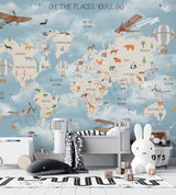 Children's room with world map wall mural and toys on a wooden floor.